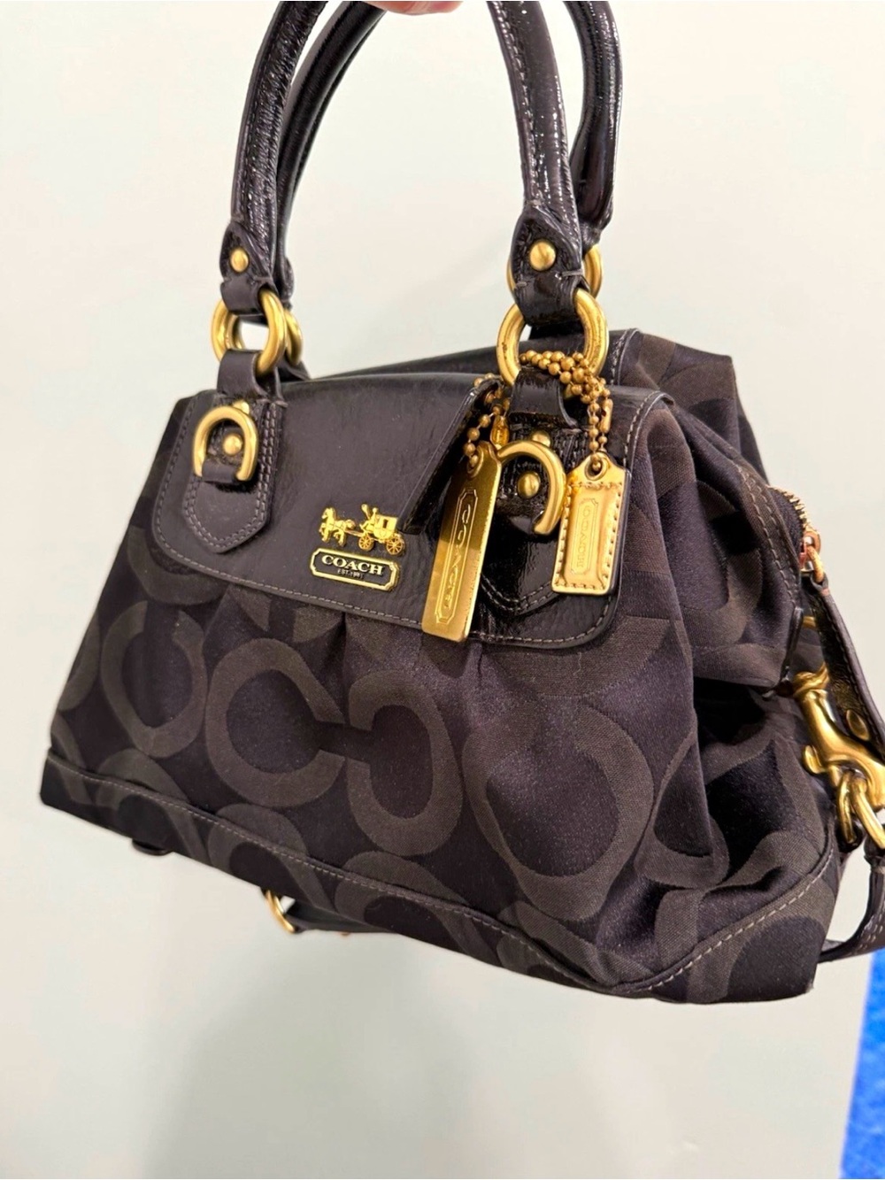 Black Coach Madison Op Art satchel features a monogram fabric body
